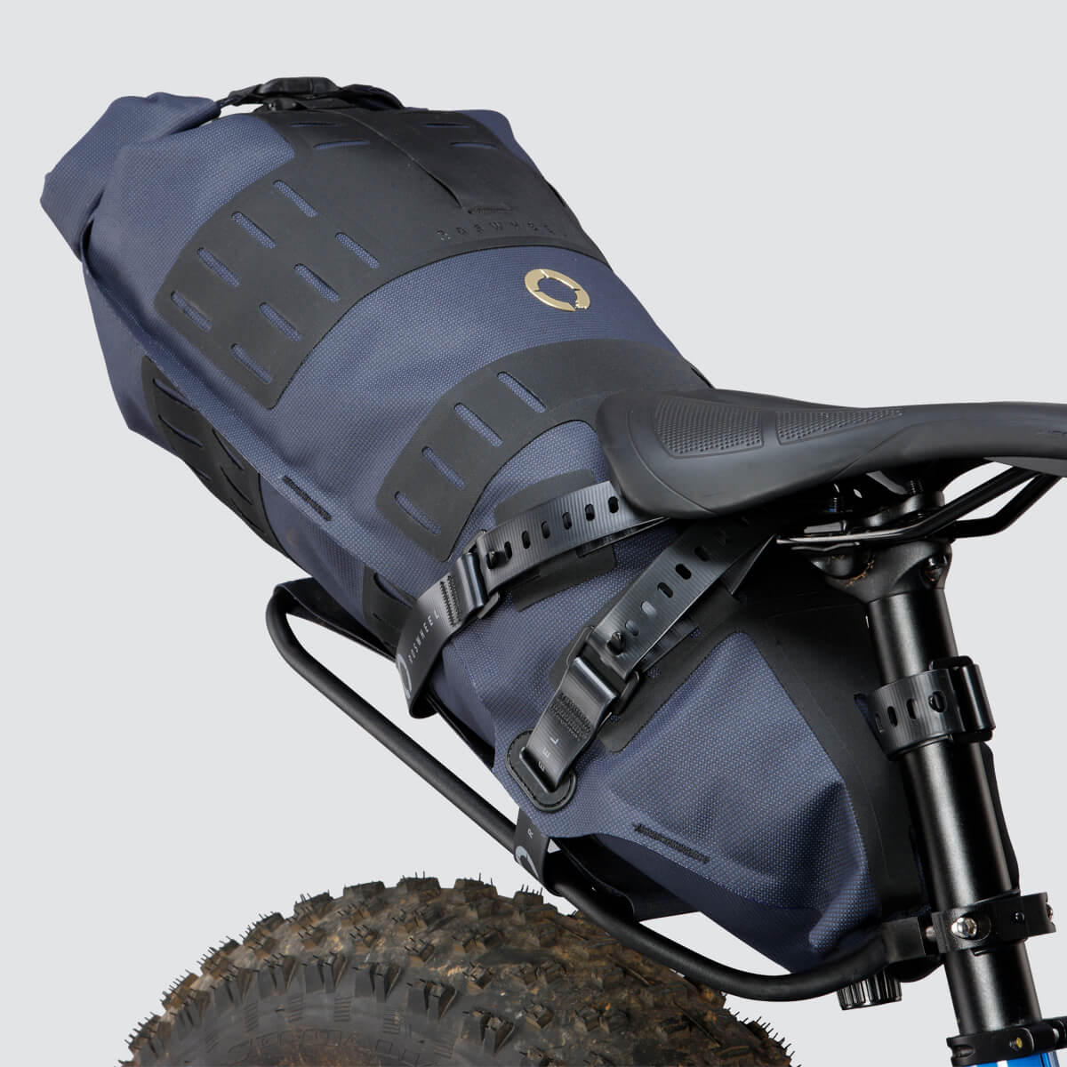 Off-Road Seat Pack Large with tapered design for easy access, featuring M.O.L.L.E. attachment system, durable waterproof fabric, and a stable adjustable rack for secure fitting.