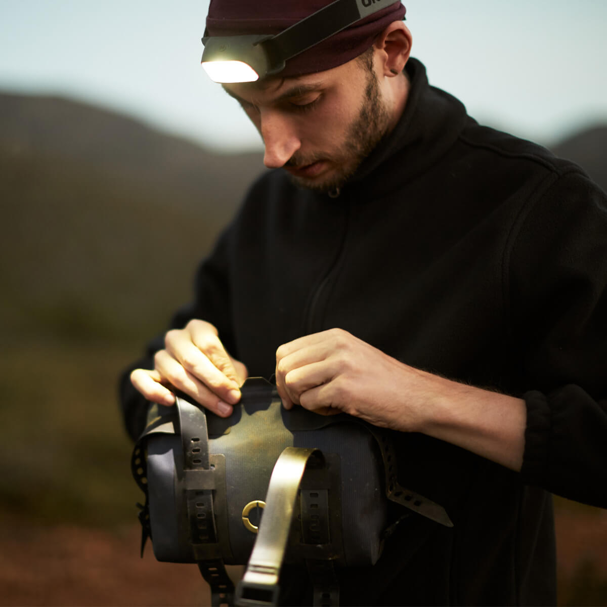 Off-Road Tool Pouch with waterproof design, inner zip pocket for organization, and M.O.L.L.E. system for flexible attachment options on the bike.